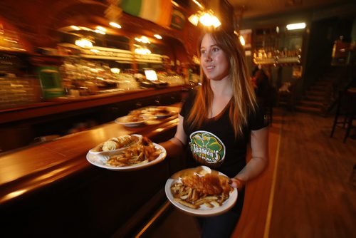 JOHN WOODS / WINNIPEG FREE PRESS Floor supervisor Karis Hutlet serves up some pub grub at Shannon's Irish Pub on Carlton Monday, March 13, 2016. Re: Sanderson