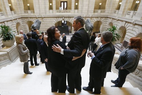 JOHN WOODS / WINNIPEG FREE PRESS PC leader Brian Pallister embraces Colleen Mayer, candidate for St Vital, after a session to dissolve government and prior to a PC candidate team photo at the Manitoba Legislature Tuesday, March 15, 2016.
