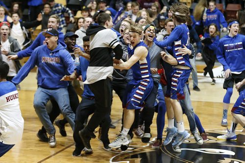 JOHN WOODS / WINNIPEG FREE PRESS Sturgeon Heights Huskies and their fans celebrate a last second win over the Garden City Fighting Gophers  in the Junior Varsity AAAA Boys Basketball Provincial Championship at the University of Manitoba Tuesday, March 15, 2016.