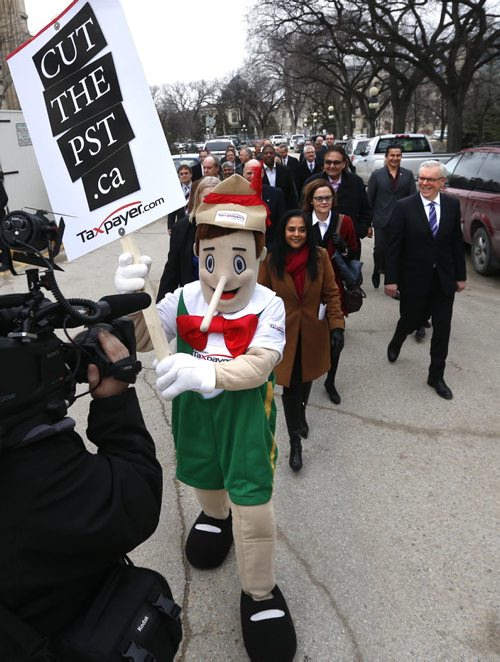WAYNE GLOWACKI / WINNIPEG FREE PRESS  A protester steps into the parade as Premier Greg Selinger at right leads  a group including NDP candidates and cabinet members from the Manitoba Legislative Bld. to visit the Lt. Gov. of Mb. to call the 2016 provincial election. Kristin Annable  story March16 2016