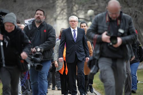 RUTH BONNEVILLE / WINNIPEG FREE PRESS  Premier Greg Selinger walks with his NDP cabinet and candidates from the Legislative Building to the Lieutenant Governor of Manitoba's Office to officially call the 2016 provincial election with a host of media hustling around him Wednesday.   March 16, 2016