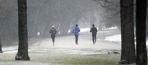 PHIL HOSSACK / WINNIPEG FREE PRESS Don't put the shovel away yet. Joggers make their way through Assinaboine Park Wednesday afternoon as some serious snow decends on the city. Accumulations may be around 5cm here with 15-20 expected in the Whiteshell and area. STAND UP WEATHER.  MARCH 16, 2016