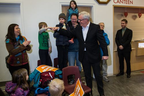 MIKE DEAL / WINNIPEG FREE PRESS NDP leader Greg Selinger fist bumps a child as he enters the gym at the party's first campaign rally at Sturgeon Creek Community Club Wednesday evening. 160316 - Wednesday, March 16, 2016