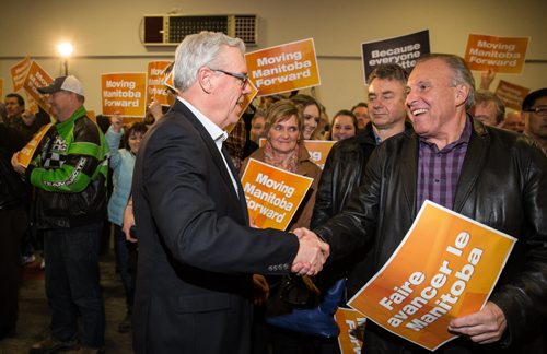 MIKE DEAL / WINNIPEG FREE PRESS NDP leader Greg Selinger shakes retiring MLA Ron Lemieux's hand as he enters the gym at the party's first campaign rally at Sturgeon Creek Community Club Wednesday evening. 160316 - Wednesday, March 16, 2016