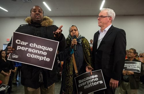 MIKE DEAL / WINNIPEG FREE PRESS Guled Gelle and his wife Farhia held up the start of the NDP rally just as their leader Greg Selinger was beginning his speech at Sturgeon Creek Community Club Wednesday evening. The Gelle's have interrupted other media events in their effort to raise awareness about the fact that three of their children have been taken into CFS care and their fourth was either sent back to Somalia or not allowed to come to Canada. 160316 - Wednesday, March 16, 2016