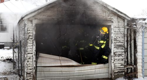WAYNE GLOWACKI / WINNIPEG FREE PRESS    Winnipeg Fire Fighters at the scene of a detached garage on fire behind a house in the 800 block of Sherburn St. Thursday afternoon. March17 2016