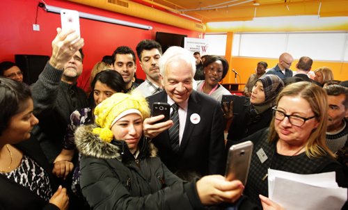 RUTH BONNEVILLE / WINNIPEG FREE PRESS  Minister of Immigration, John McCallum is bombarded by Syrian Refugees wanting to get selfless with him after a press conference announcing $500 000 for Syrian Refugees Thursday at Welcome Place.   March 17, 2016