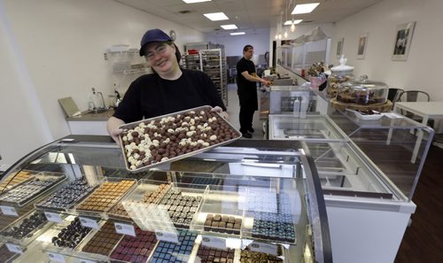 WAYNE GLOWACKI / WINNIPEG FREE PRESS  Decadence Chocolates owner Helen Staines with a tray of mini Easter chocolate eggs.  (In back is Dan Gallardo.)  Gord Sinclair  story March 17 2016