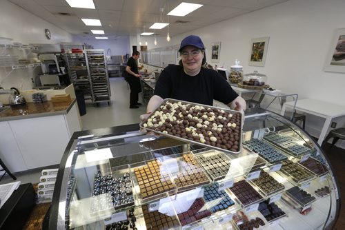 WAYNE GLOWACKI / WINNIPEG FREE PRESS  Decadence Chocolates owner Helen Staines with a tray of mini Easter chocolate eggs. (In back is Dan Gallardo.)  Gord Sinclair  story March 17 2016