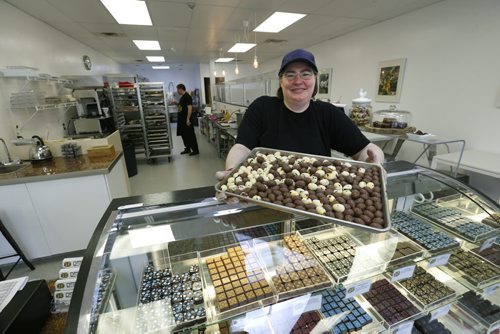 WAYNE GLOWACKI / WINNIPEG FREE PRESS  Decadence Chocolates owner Helen Staines with a tray of mini Easter chocolate eggs.  (In back is Dan Gallardo.) Gord Sinclair  story March 17 2016