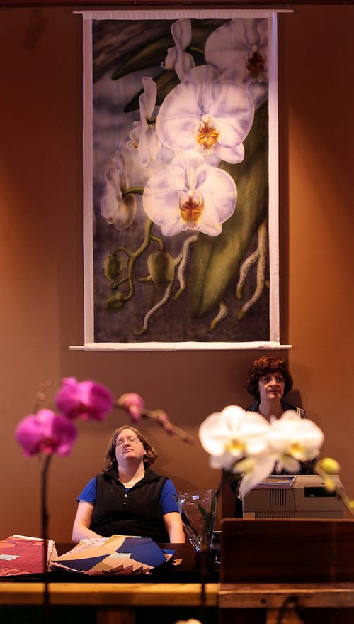 PHIL HOSSACK / WINNIPEG FREE PRESS Orchids - Workers wait to wrap sales of Orchids Friday morning as the Annual Orchid show opened at the Assiniboine Park Conservatory. The show runs all weekend. See Doug Spiers story - STAND-UP  MARCH 18, 2016