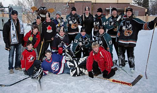 BORIS MINKEVICH / WINNIPEG FREE PRESS  080303 Moose players pose with youngsters in the backyard rink belonging to Dennis Sworyk of 1249 Pandora Ave. The annual event is put on by The Manitoba Moose and The Home Depot. One rink is selected to host the event.