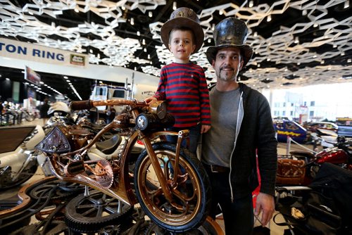 TREVOR HAGAN / WINNIPEG FREE PRESS At the World of Wheels car show at the Winnipeg Convention Centre, Nathan Kovacs, 5, and his father Krisztian, who built this bicycle from scratch using black walnut wood and metal parts, Friday, March 18, 2016.