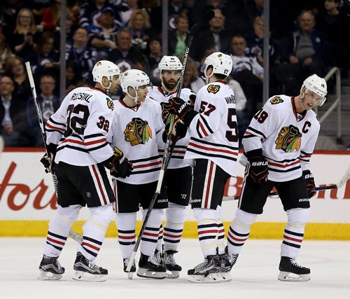 TREVOR HAGAN / WINNIPEG FREE PRESS Chicago Blackhawks' Michal Rozsival (32), Patrick Kane (88), Andrew Ladd (16), Trevor can Riemsdyk (57) and Jonathan Toews (19) celebrate after Kane scored against the Winnipeg Jets' during second period NHL hockey action, Friday, March 18, 2016.
