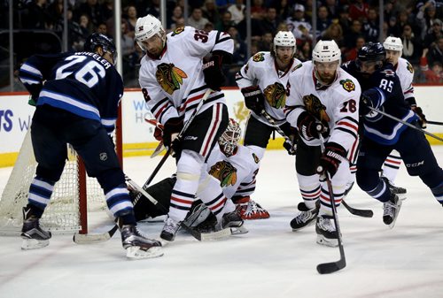 TREVOR HAGAN / WINNIPEG FREE PRESS Winnipeg Jets' Blake Wheeler (26) and Mathieu Perreault (85) battle with Chicago Blackhawks' Michal Rozsival (32) and Andrew Ladd (16) in front of goaltender Scott Darling (33) during second period NHL hockey action, Friday, March 18, 2016.