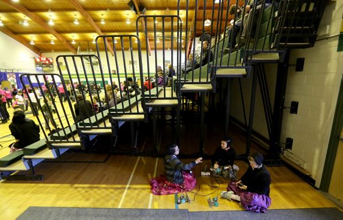 TREVOR HAGAN / WINNIPEG FREE PRESS Tirzah Wollmann, 12, Janae Waldner, 10 and Larissa Wollmann, 11, from the Poplar Point Hutterite Colony, playing with robots under the bleachers at the 21st annual Manitoba Robot Games, being held at Tec-Voc High School, Saturday, March 19, 2016.