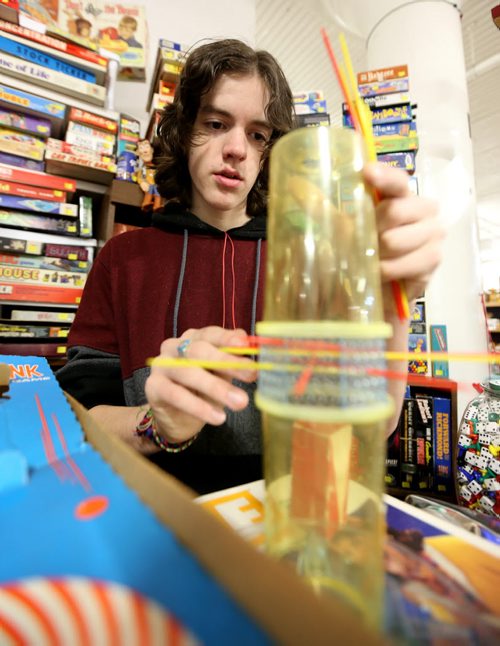 TREVOR HAGAN / WINNIPEG FREE PRESS Tanner, 16, setting up KERPLUNK, in the Mulvey flea market booth that sells games owned by his dad, Rusty , Saturday, March 19, 2016. For Dave Sanderson 49.9 story