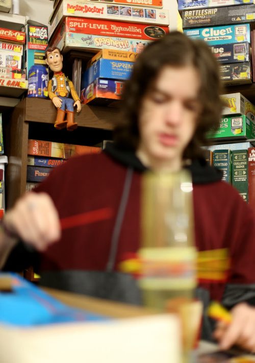 TREVOR HAGAN / WINNIPEG FREE PRESS Woody from Toy Story watches as Tanner, 16, plays KERPLUNK in the Mulvey flea market booth selling games owned by his dad, Rusty , Saturday, March 19, 2016. For Dave Sanderson 49.9 story