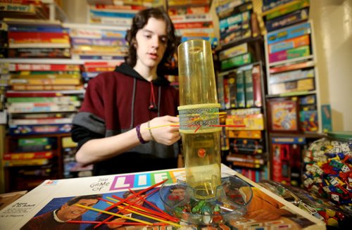 TREVOR HAGAN / WINNIPEG FREE PRESS Tanner, 16, playing KERPLUNK in the Mulvey flea market booth selling games owned by his dad, Rusty , Saturday, March 19, 2016. For Dave Sanderson 49.9 story