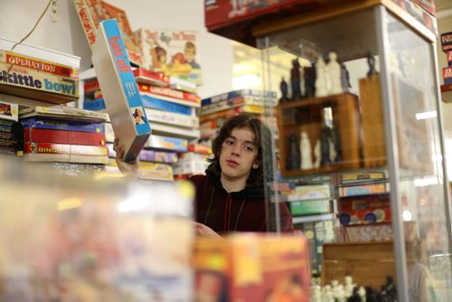 TREVOR HAGAN / WINNIPEG FREE PRESS Tanner, 16, in the Mulvey flea market booth selling games owned by his dad, Rusty , Saturday, March 19, 2016. For Dave Sanderson 49.9 story