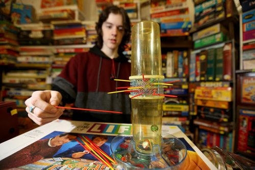 TREVOR HAGAN / WINNIPEG FREE PRESS Tanner, 16, playing KERPLUNK in the Mulvey flea market booth selling games owned by his dad, Rusty , Saturday, March 19, 2016. For Dave Sanderson 49.9 story