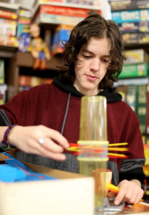 TREVOR HAGAN / WINNIPEG FREE PRESS Tanner, 16, playing KERPLUNK in the Mulvey flea market booth selling games owned by his dad, Rusty , Saturday, March 19, 2016. For Dave Sanderson 49.9 story