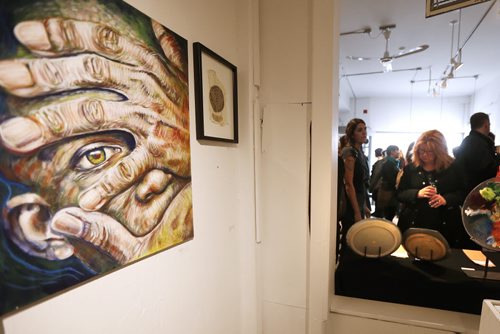 JOHN WOODS / WINNIPEG FREE PRESS People check out the art at the Mentoring Artists for Women's Art (MAWA) fundraiser Over The Top Art Auction and Cupcake Party in Winnipeg Sunday, March 20, 2016. MAWA supports women visual artists through mentorship, education and critical dialogue.