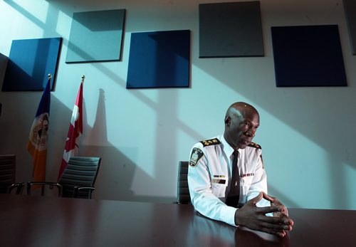 PHIL HOSSACK / WINNIPEG FREE PRESS Winnipeg Police Chief Devon Clunis crunches the numbers from the perspective of his new boardroom on Donald street's new HQ building on the eve of the city budget passing. See Katie May's story   MARCH 17, 2016