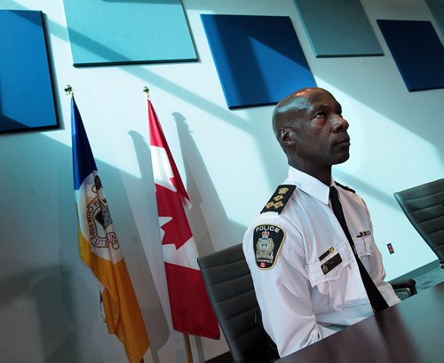 PHIL HOSSACK / WINNIPEG FREE PRESS Winnipeg Police Chief Devon Clunis crunches the numbers from the perspective of his new boardroom on Donald street's new HQ building on the eve of the city budget passing. See Katie May's story   MARCH 17, 2016