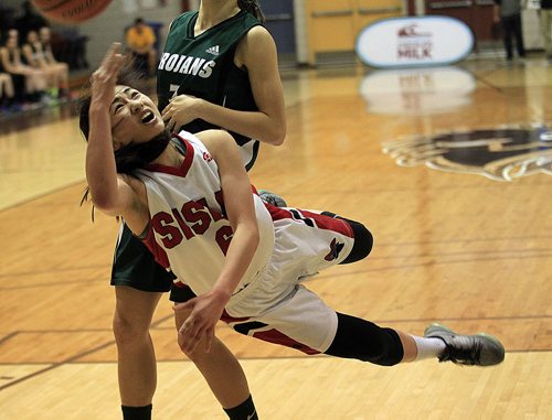 PHIL HOSSACK / WINNIPEG FREE PRESS Sisler Spartan #6 Raizel Guinto, gets the ball up to the net against Vincent Massey Trojan #7 Victoria Tachinski Monday evening during the MHSAA Basketball Championship final Monday at Investor's Group Athletic Center.  MARCH 21, 2016