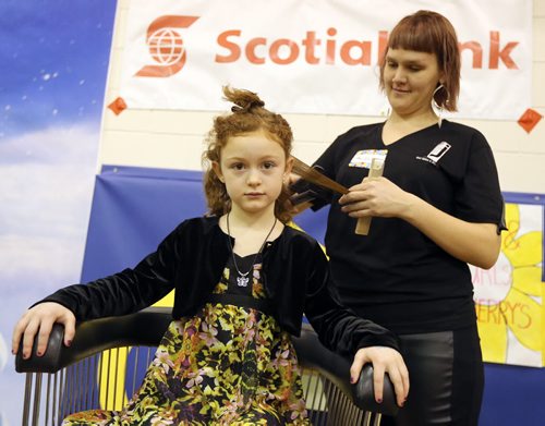 JASON HALSTEAD / WINNIPEG FREE PRESS  Merita Ferrada of Jerry's Hair Salon and Day Spa does the hair of Gr. 1 student Charlotte Martens at Ecole Robert H. Smith School's ninth annual community breakfast on March 4, 2016. This year, money raised by the River Heights school will go to the Children's Rehabilitation Foundation. (See Social Page)