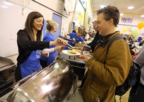 JASON HALSTEAD / WINNIPEG FREE PRESS  Carla Anjos-Clemente from the Corydon Village Royal Bank serves breakfast at Ecole Robert H. Smith School's ninth annual community breakfast on March 4, 2016. This year, money raised by the River Heights school will go to the Children's Rehabilitation Foundation. (See Social Page)