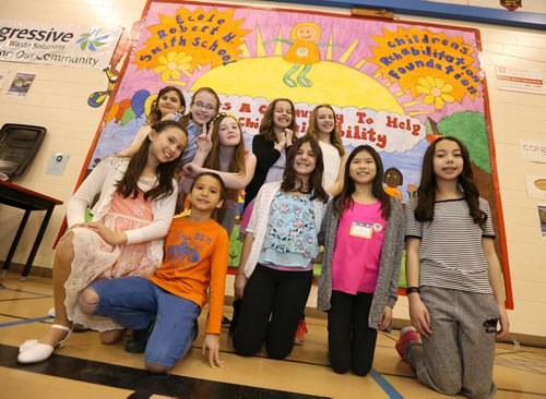 JASON HALSTEAD / WINNIPEG FREE PRESS  Ecole Robert H. Smith School students (rear, from left) Shaelyn Eck, Charlotte Broadhurst, Juliette Steed, Maddie Janzen and Kate Stephenson and (front, left to right) Alyssa Danner, Eric Danner, Silvana Scaramuzzi, Cate Carson and Sydney Guevarra in front of the mural they created for the school's ninth annual community breakfast on March 4, 2016. This year, money raised by the River Heights school will go to the Children's Rehabilitation Foundation. (See Social Page)