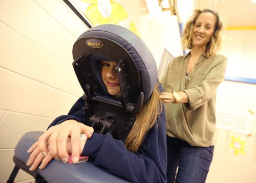 JASON HALSTEAD / WINNIPEG FREE PRESS  Physiotherapist Mandy Connell of River Heights Physiotherapy gives a massage to Westgate Collegiate Gr. 9 student Abi Wainikka at Ecole Robert H. Smith School's ninth annual community breakfast on March 4, 2016. This year, money raised by the River Heights school will go to the Children's Rehabilitation Foundation. (See Social Page)