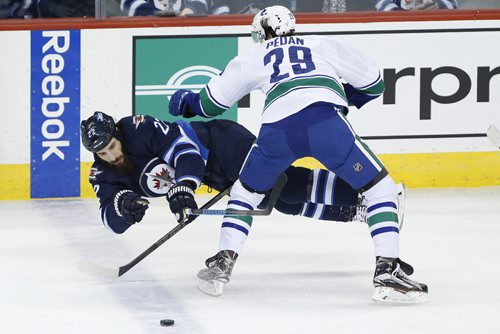 JOHN WOODS / WINNIPEG FREE PRESS Vancouver Canucks' Andrey Pedan (29) knocks Winnipeg Jets' Chris Thorburn (22) off the puck during first period NHL action in Winnipeg on Tuesday, March 22, 2016.