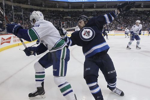 JOHN WOODS / WINNIPEG FREE PRESS Winnipeg Jets' Chase De Leo (77) gets checked by Vancouver Canucks' Brendan Gaunce (50) during second period NHL action in Winnipeg on Tuesday, March 22, 2016.