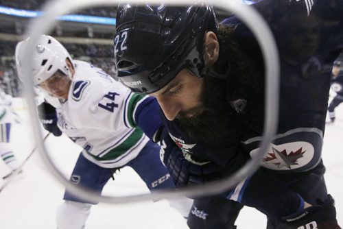 JOHN WOODS / WINNIPEG FREE PRESS Winnipeg Jets' Chris Thorburn (22) and Vancouver Canucks'vc44\ go into the corner for a loose puck during second period NHL action in Winnipeg on Tuesday, March 22, 2016.