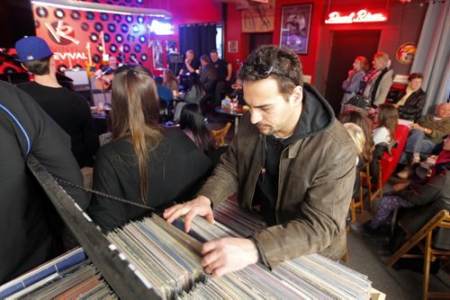 BORIS MINKEVICH / WINNIPEG FREE PRESS Vinyl Revival - for photo page on the store's open mic night every Wednesday. It's a really cool vibe/atmosphere. It usually gets about 50-60 people. NO ID ON THIS FELLA looking for records in the store. Photo taken March 23, 2016