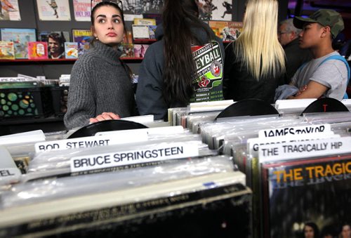 BORIS MINKEVICH / WINNIPEG FREE PRESS Vinyl Revival - for photo page on the store's open mic night every Wednesday. It's a really cool vibe/atmosphere. It usually gets about 50-60 people. left- Celine Leclerc,15, hangs with her pals and takes in the vibe. Photo taken March 23, 2016