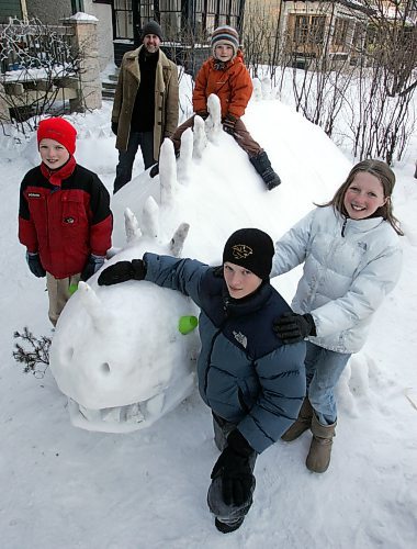 BORIS MINKEVICH / WINNIPEG FREE PRESS  080305 L-R  Tynan Caine,9, Mat Hannay(uncle), Soran Caine,6, Dixon Caine,14, and Jonina Caine,11, pose around Steggy the Snowasorus. Steggy is over 30 feet long from head to tail and took 2 days for the kids with their uncle Mat to create the fun winter snow sculpture.