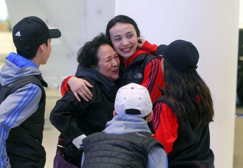 BORIS MINKEVICH / WINNIPEG FREE PRESS Skyler Park, middle,  gets a warm welcome by her grandmother Kay Park and some other friends and family at the James Armstrong Richardson International Airport. Some of the participants on the Winnipeg taekwondo team that arrived at the Brussels airport just minutes after the bombs went off are due back in Winnipeg this afternoon. Photo taken March 24, 2016
