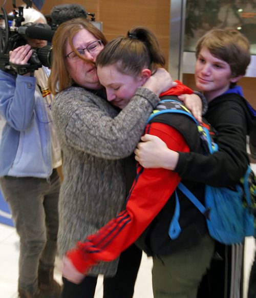 BORIS MINKEVICH / WINNIPEG FREE PRESS (mother) Charlynne Diduch, left, competitor Shelby Diduch, and little brother Tyler. Families are happy to see their kids arrive home at James Armstrong Richardson International Airport. Some of the participants on the Winnipeg taekwondo team that arrived at the Brussels airport just minutes after the bombs went off are due back in Winnipeg this afternoon. Photo taken March 24, 2016