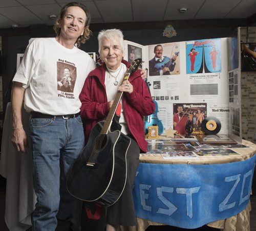 DAVID LIPNOWSKI / WINNIPEG FREE PRESS  Tim Frisk, the stepson of legendary Winnipeg-born fiddler, Reg Bouvette with his mother Beryl Bouvette photographed Thursday  March 24, 2016 at the Nicolett Inn with Reg Bouvette memorabilia.  Frisk is now the fiddler's number one fan. He staged Reg Fest three years ago, and he's looking for memorabilia associated with Bouvette, in case he stages another Reg Fest in the future.    49.8 INTERSECTION - fiddler tale