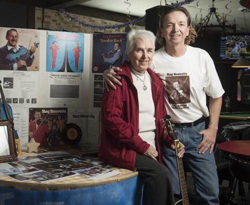 DAVID LIPNOWSKI / WINNIPEG FREE PRESS  Tim Frisk, the stepson of legendary Winnipeg-born fiddler, Reg Bouvette with his mother Beryl Bouvette photographed Thursday  March 24, 2016 at the Nicolett Inn with Reg Bouvette memorabilia.  Frisk is now the fiddler's number one fan. He staged Reg Fest three years ago, and he's looking for memorabilia associated with Bouvette, in case he stages another Reg Fest in the future.    49.8 INTERSECTION - fiddler tale