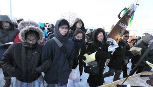 PHIL HOSSACK / WINNIPEG FREE PRESS Arm in arm, a thousand of the faithfull in a public procession from St Peter's Church on Keewatin street Friday morning to follow the "Stations of the Cross" as Easter weekend begins for Christians world wide. See Scott Billeck story. March 25, 2016