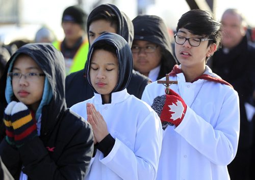 PHIL HOSSACK / WINNIPEG FREE PRESS Altar Boys in prayer take part in a procession of a thousand or more faithfull as they leave St Peter's Church on Keewatin street Friday morning to follow the "Stations of the Cross" as Easter weekend begins for Christians world wide. See Scott Billeck story. March 25, 2016