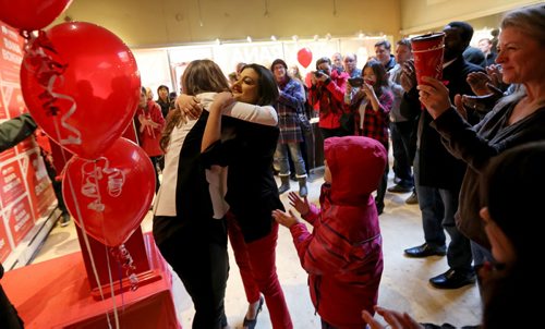 TREVOR HAGAN / WINNIPEG FREE PRESS Liberal Party leader, Rana Bokhari, right, embraces Johanna Wood, MLA candidate for Fort Garry-Riverview, at the opening of her campaign headquarters in Osborne Village, Saturday, March 26, 2016.