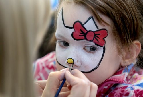 TREVOR HAGAN / WINNIPEG FREE PRESS Mya Derksen, 4, has her face painted by Danielle Zacharias, at the Festival of Fools at The Forks, Saturday, March 26, 2016.