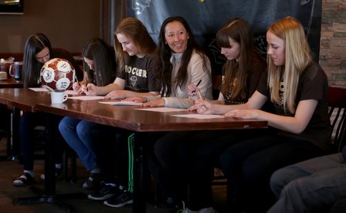 TREVOR HAGAN / WINNIPEG FREE PRESS Soccer players, Haydn Burdeny, Sarah Lyle, Camille Forbes, head coach Vanessa Martinez Lagunas, Shaylyn Dyck and Rebecca Martin, sign their intent to join the University of Manitoba Bisons team, during a press conference at Smitty's on Pembina, Monday, March 28, 2016.