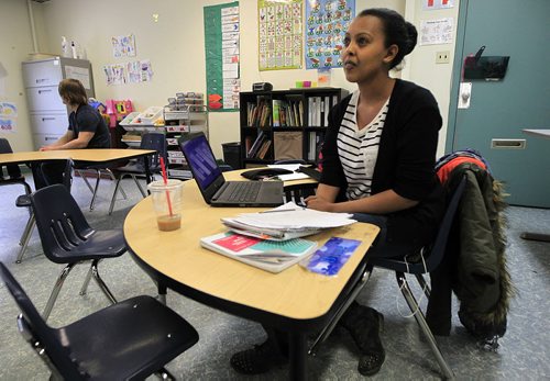 PHIL HOSSACK / WINNIPEG FREE PRESS Moustariha Mohammed (19) sits at a childs desk at the NEEDS Centre on Notre Dame Tuesday doing her homework. Five years after arriving in Canada unable to speak English, she's working on a science degree at U of M hoping to become a doctor.  See Carol Sanders story. MARCH 29, 2016